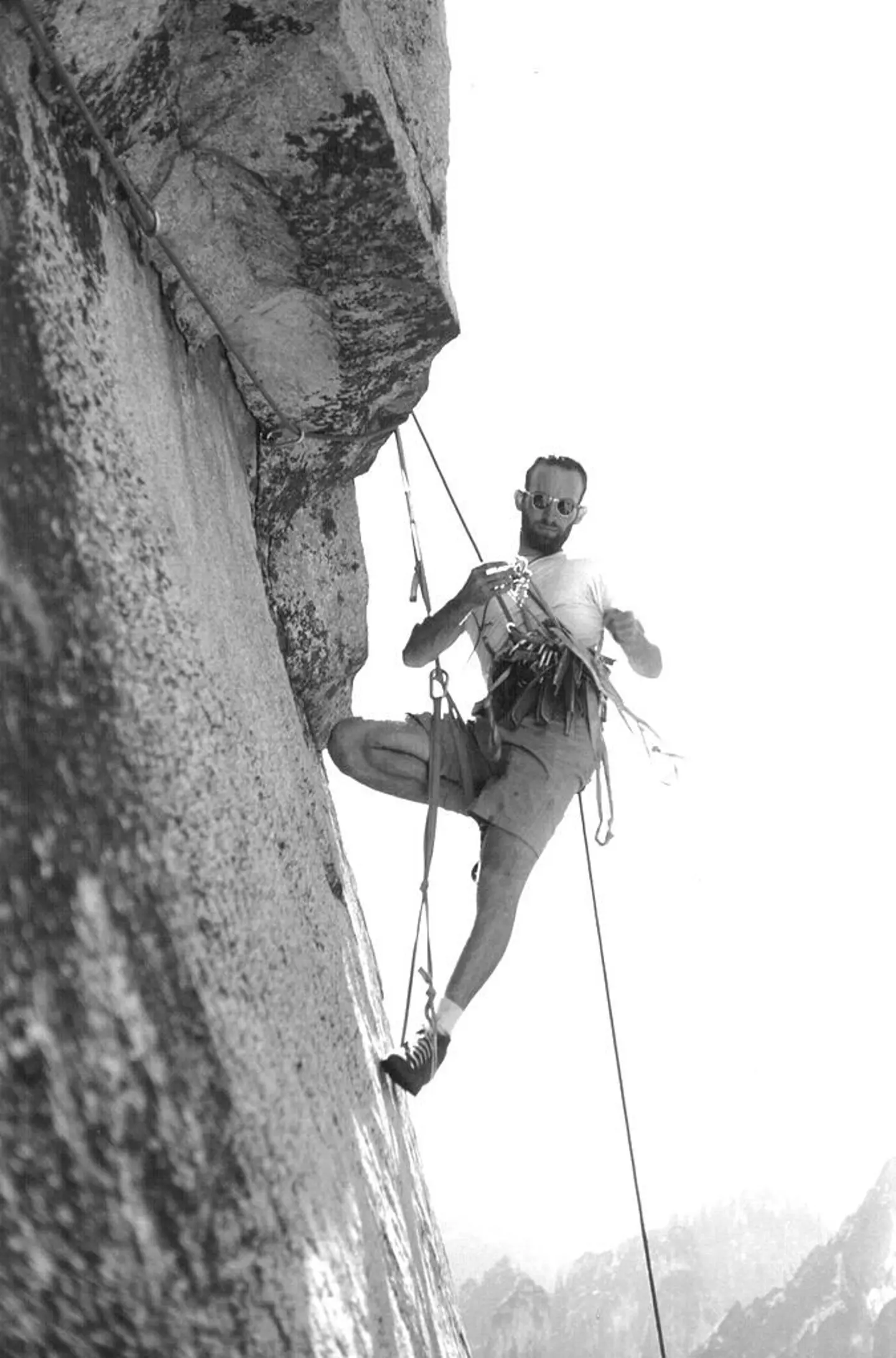 Royal Robbins on El Capitan, his harness racked with the tools of the ascent.